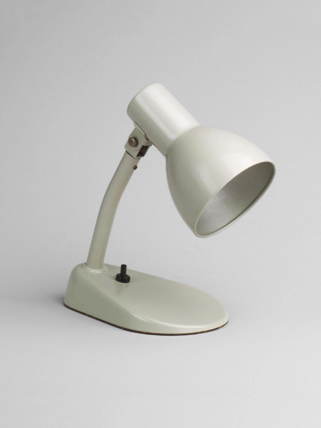 Cream metal table lamp with a swivelling shade on an oval base