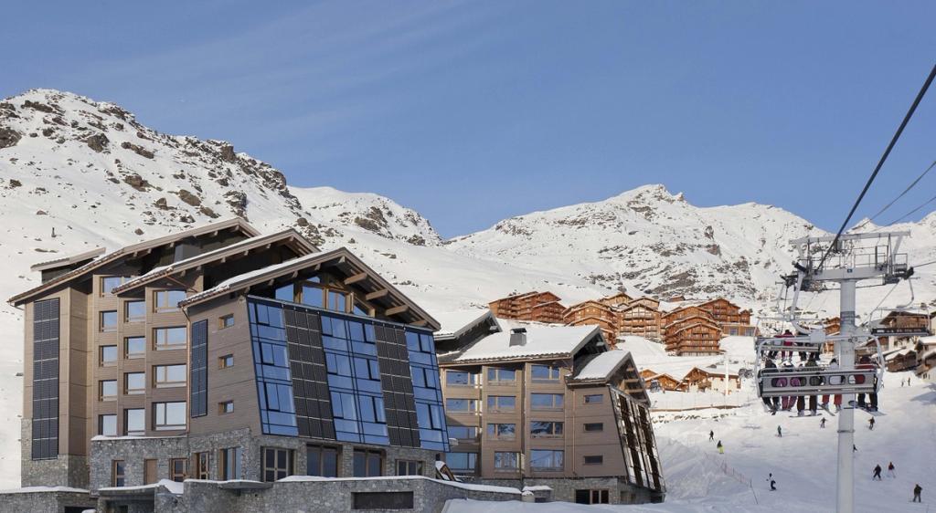 The Altapura buildings in Val Thorens beside a ski lift, with snow-covered slopes behind