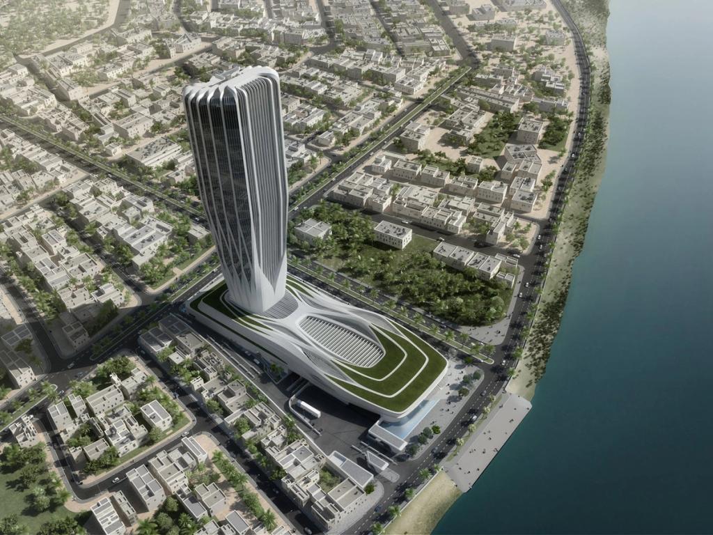 Aerial view of a high-rise tower with a ribbed facade and a green, curved stylobate at the water's edge