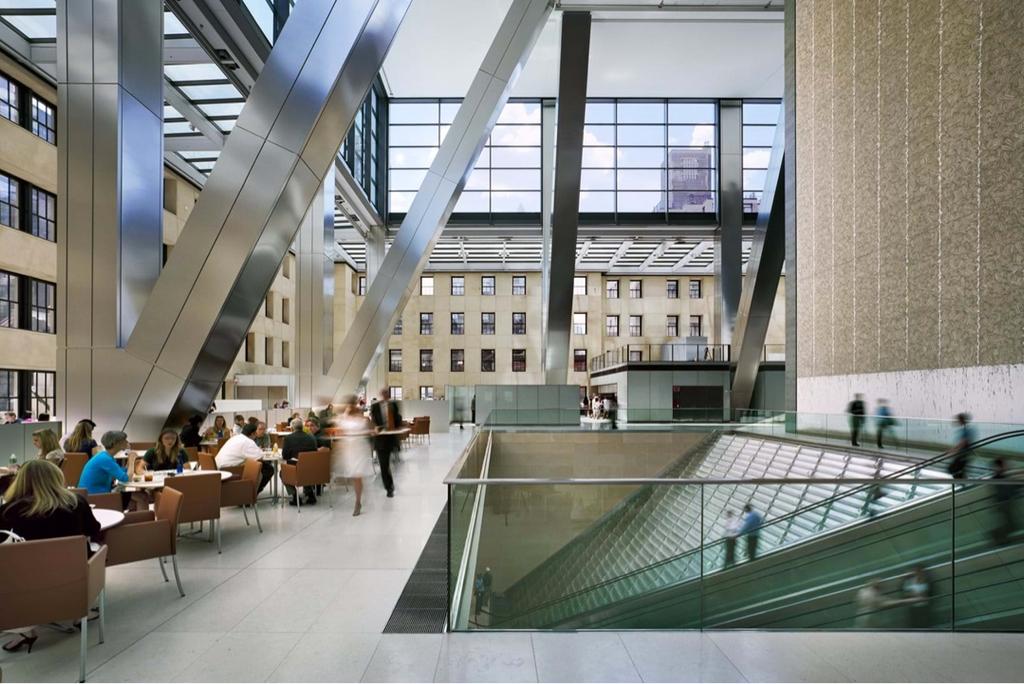 The public interior of the Hearst Tower with diagonal columns, a café and escalators
