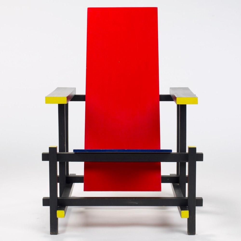 Rietveld's Red and Blue Chair from the front, with yellow ends on the armrests