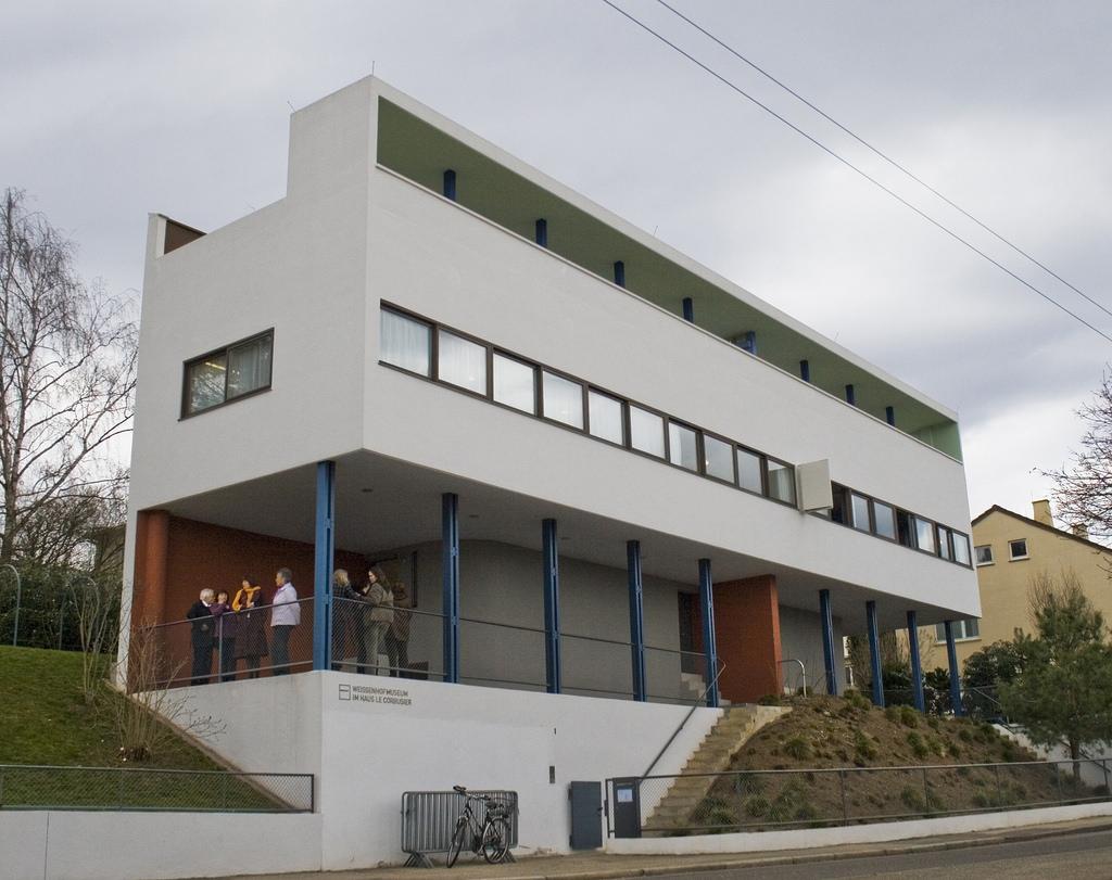 The Weissenhof house in Stuttgart, a white volume on blue pilotis with a green stripe