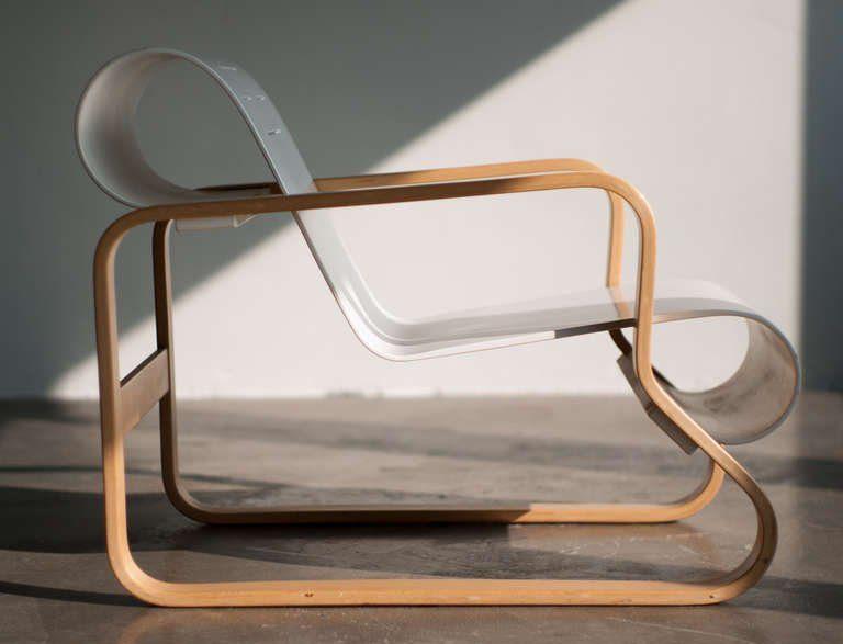 Alvar Aalto's Paimio Armchair in profile, curved seat and armrests in bent birch