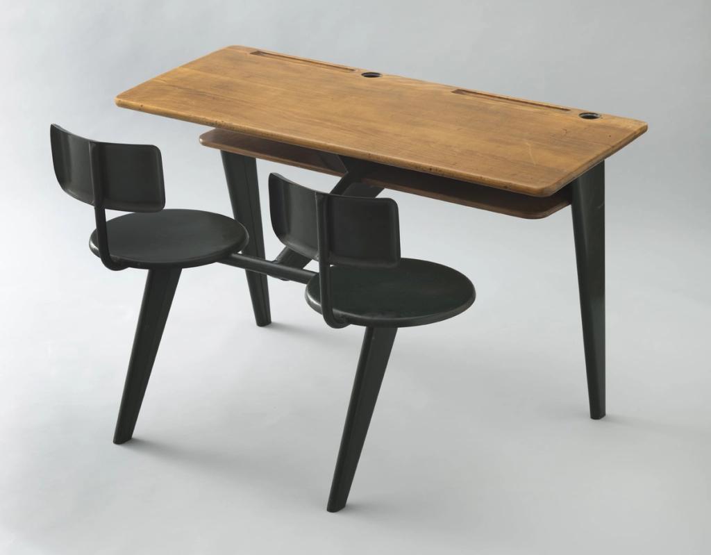 Jean Prouvé's school desk with built-in black seats and a wooden tabletop