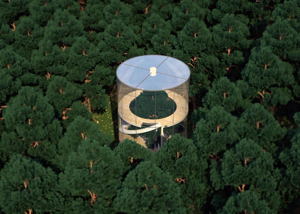Aerial view of a round glass house in a dense forest
