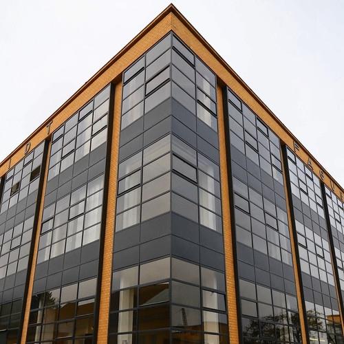 Corner of the Fagus Factory: glazed curtain-wall facade between brick piers