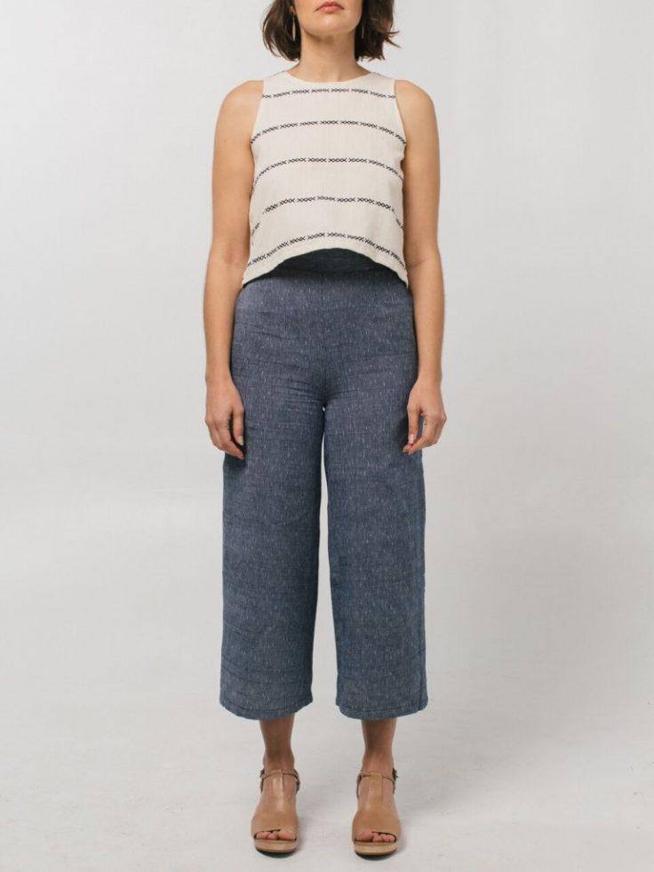 A model in a cream embroidered top and blue linen culottes by Tribe Alive