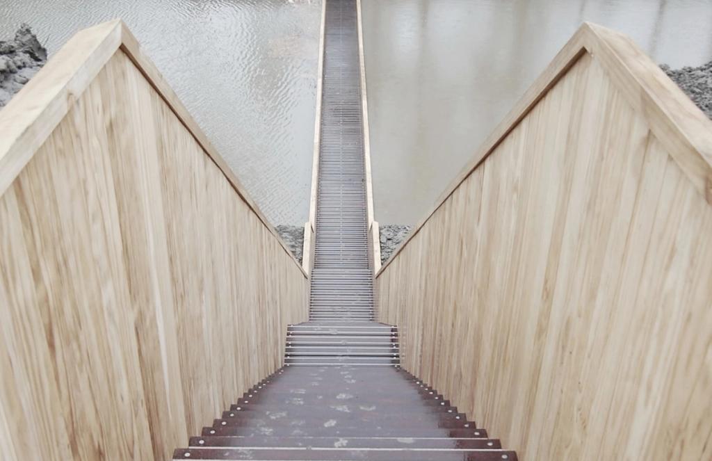 Descending the steps inside the sunken timber Moses Bridge, at water level
