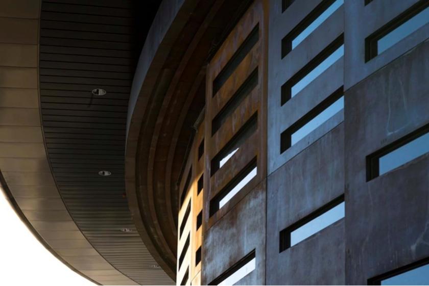 Detail of the rounded overhanging volume and facade of Spaceport America, seen from below