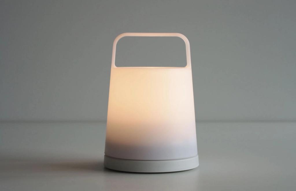 White portable lantern-style lamp with a handle and warm glow