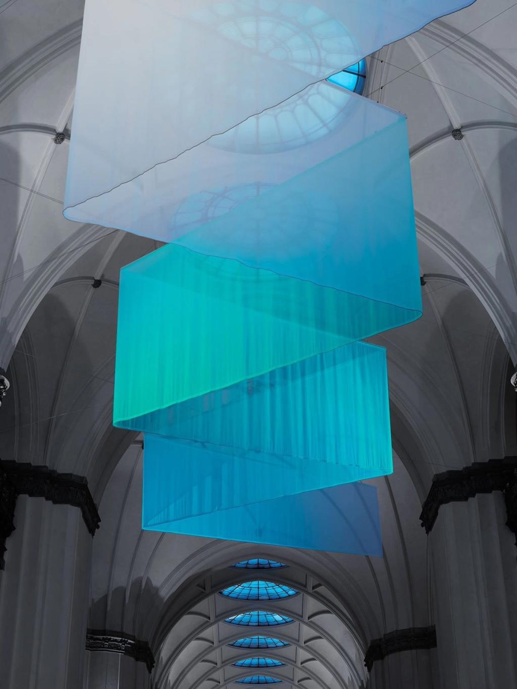The Mangata installation — a spiral of blue fabric beneath the vaulted ceiling of a Stockholm hall