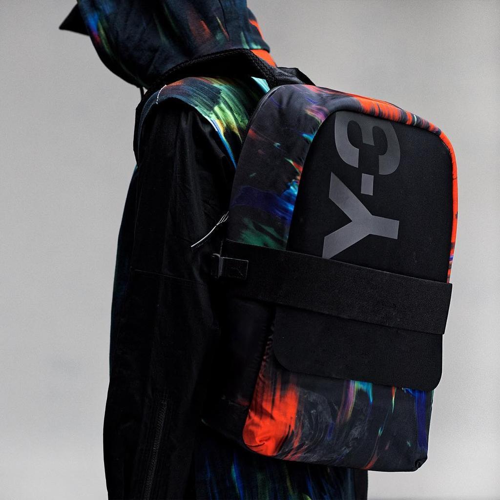 A Y-3 black hobo bag held by a girl in white shorts and an Adidas sweatshirt