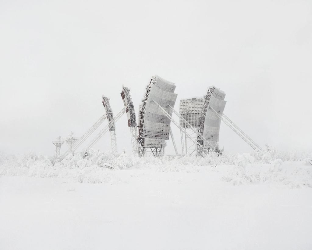 Frost-covered metal antennas of a radar station in a snowy tundra