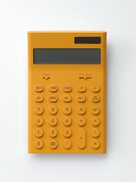 A mustard-yellow desktop calculator with round buttons and a solar panel