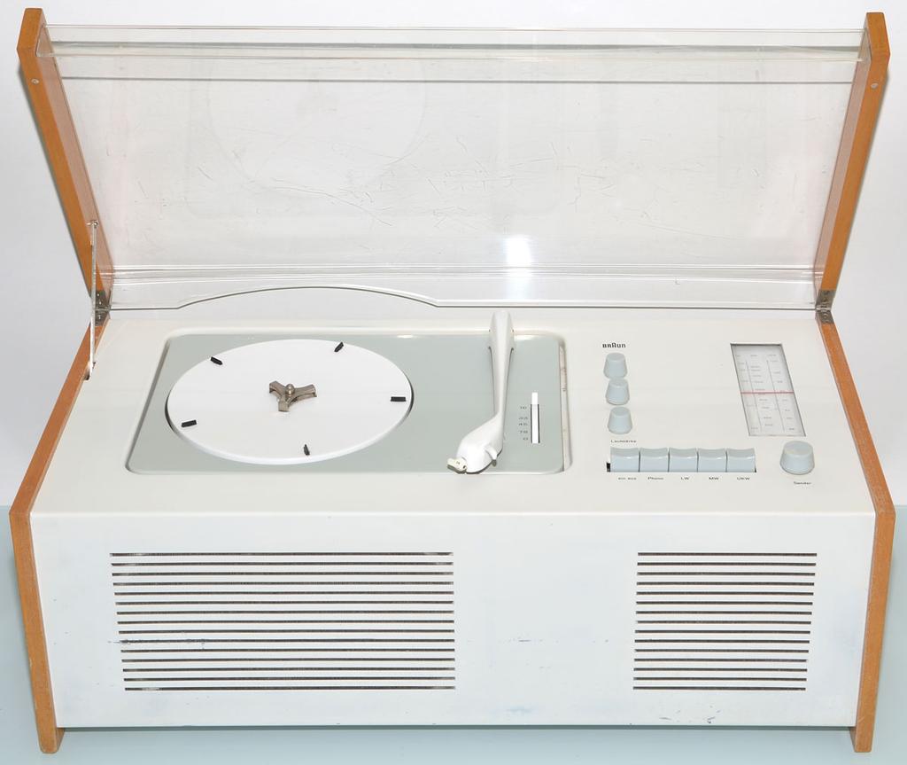 The Braun SK4 record player with its transparent lid raised, showing the white body and wooden side panels