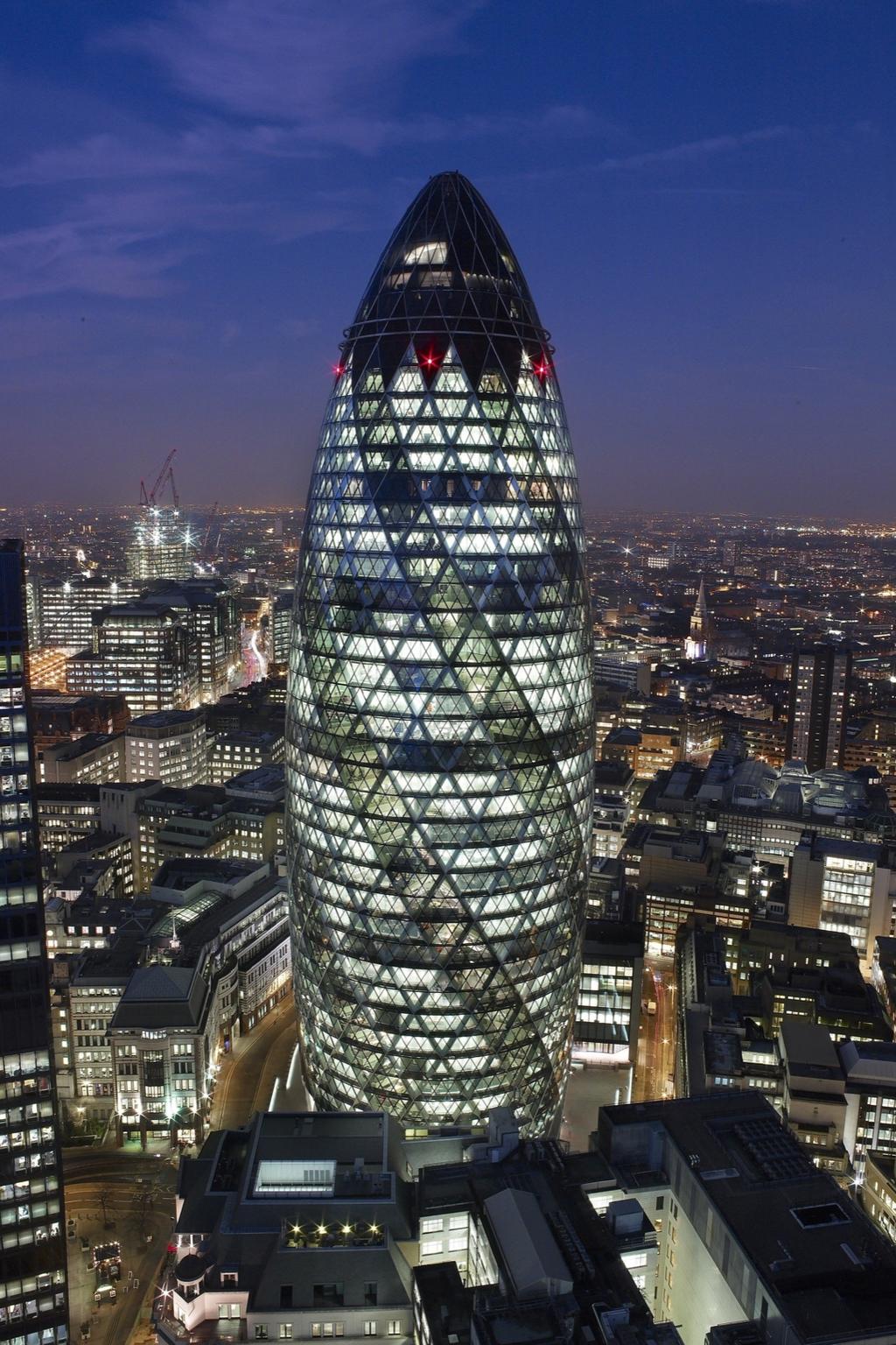 30 St Mary Axe illuminated at dusk above the night panorama of London