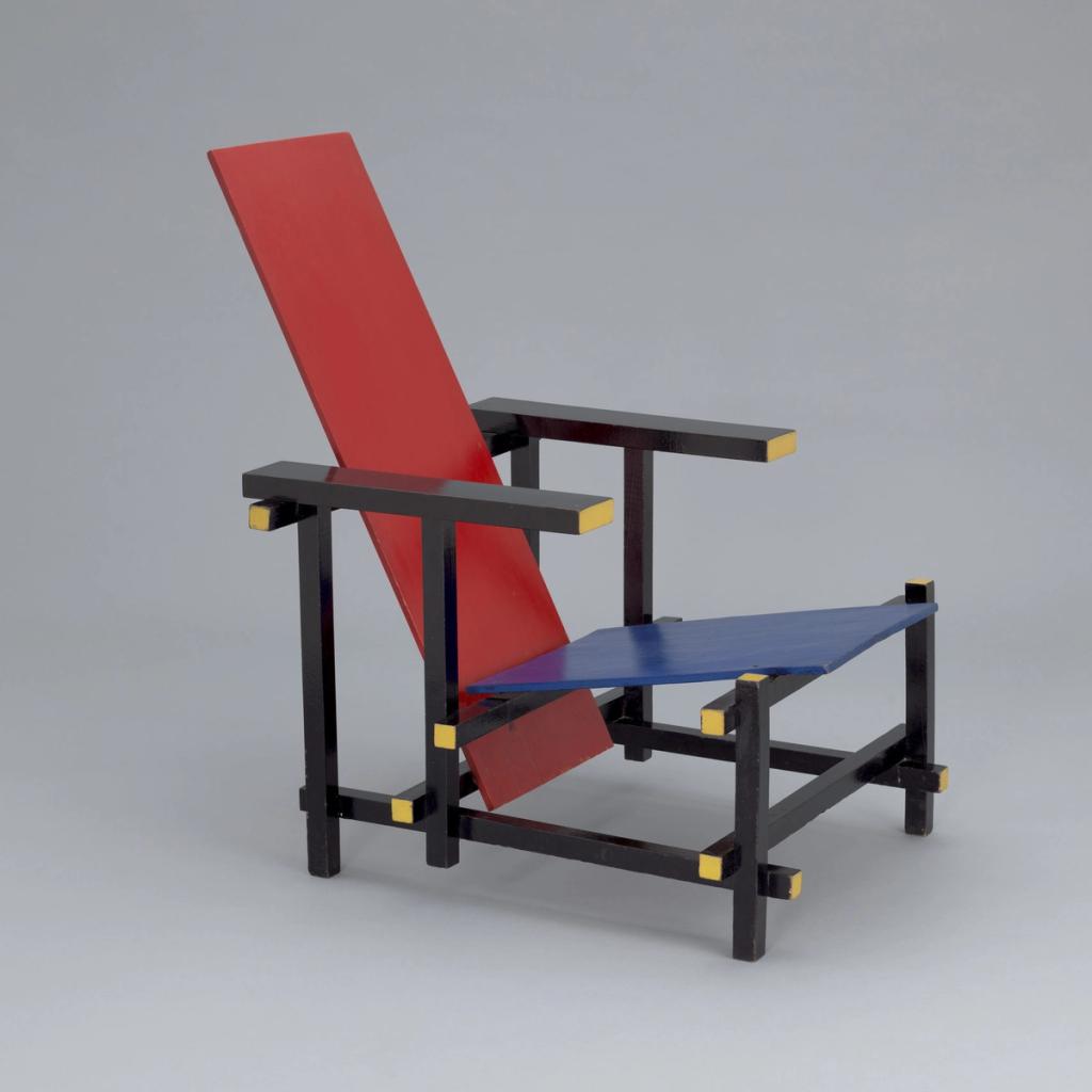 Gerrit Rietveld's Red and Blue Chair, constructed from flat painted boards with a black frame and yellow ends