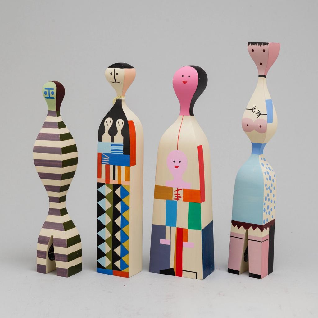 Four of Alexander Girard's Wooden Dolls with bright geometric painted decoration