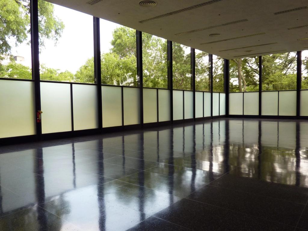 The open hall of Crown Hall with panoramic glazing and a dark floor