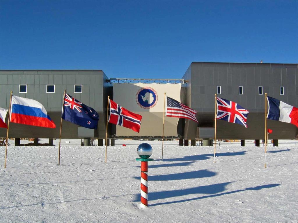 The Amundsen–Scott Station building with national flags at the South Pole