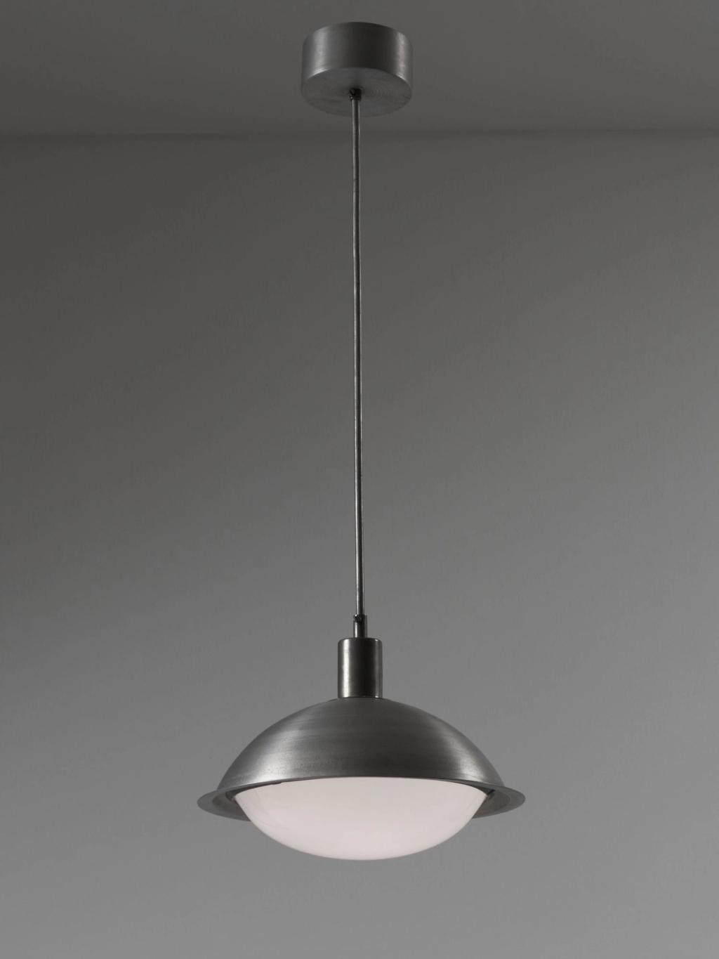 Pendant light with a metal dome and white glass diffuser on a long cord