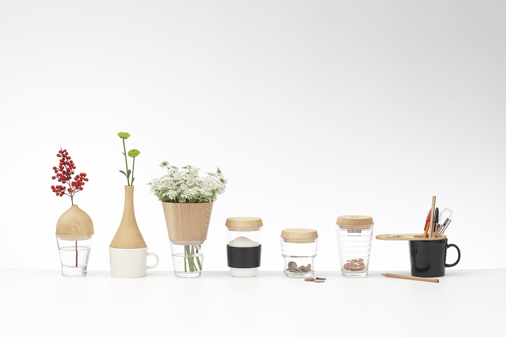 A set of desk vases and glasses with wooden lids and flowers