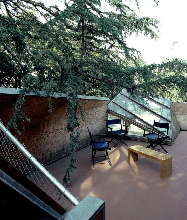 The rooftop terrace of Gehry's house, with chairs, a bench and an angled glass skylight