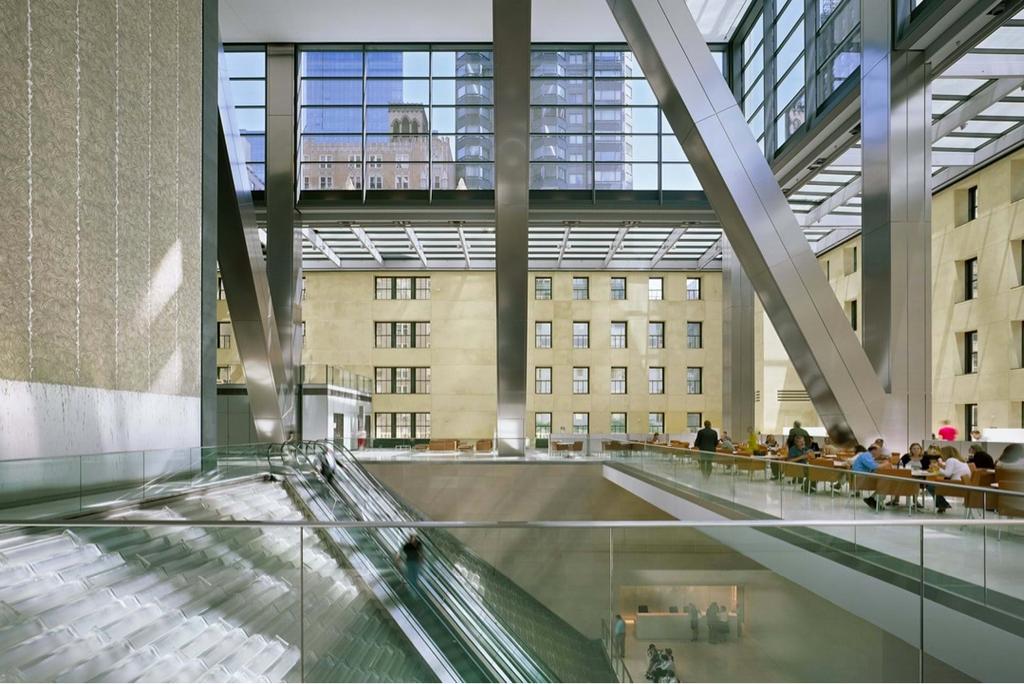 The atrium of the Hearst Tower with its glass roof, water wall and preserved original facade