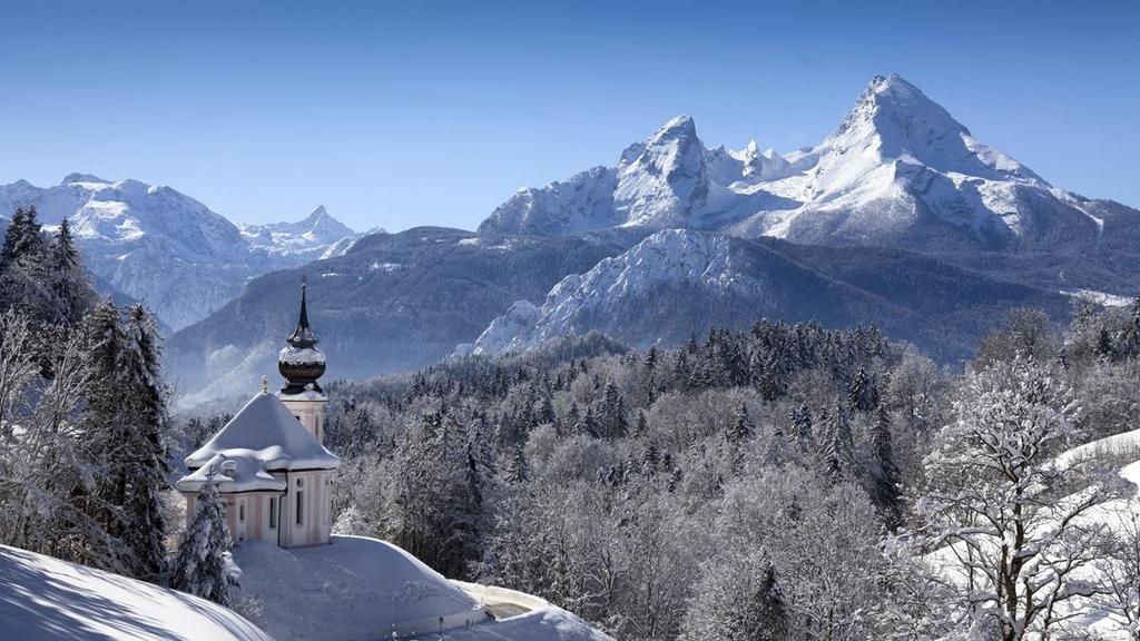 The snow-covered Maria Gern chapel against the backdrop of the Watzmann massif in the Bavarian Alps