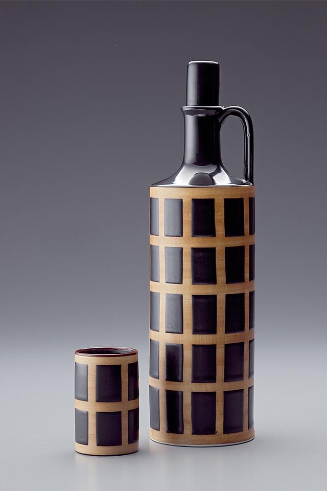 Ceramic bottle with a black-and-beige checked pattern and a small cup