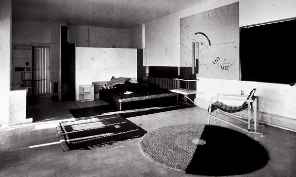The white modernist Villa E-1027 on pilotis, with its terrace and external staircase set among greenery