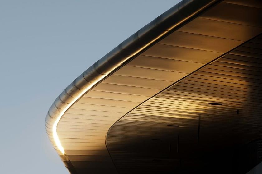 Close-up of the curved metal eave of Spaceport America's roof against the sky