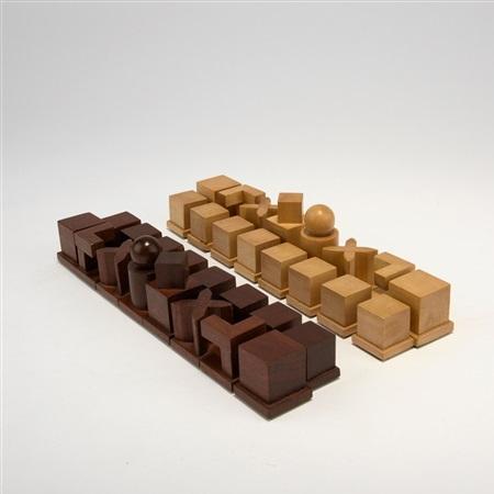 The Hartwig chess set with light and dark wooden pieces arranged in two trays