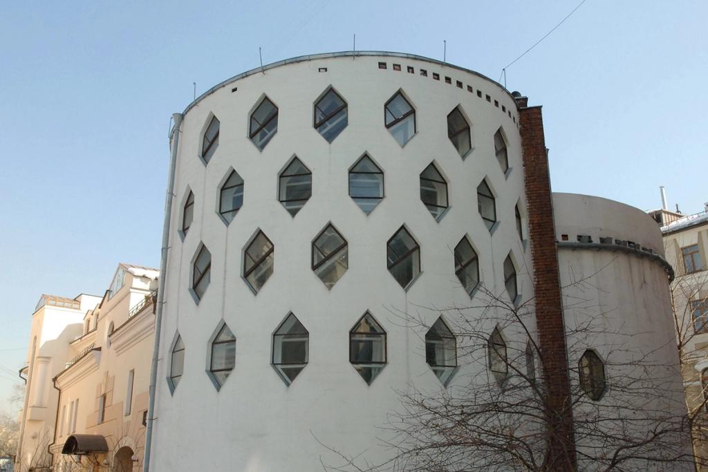 The white tower of the Melnikov House with hexagonal windows against a winter sky