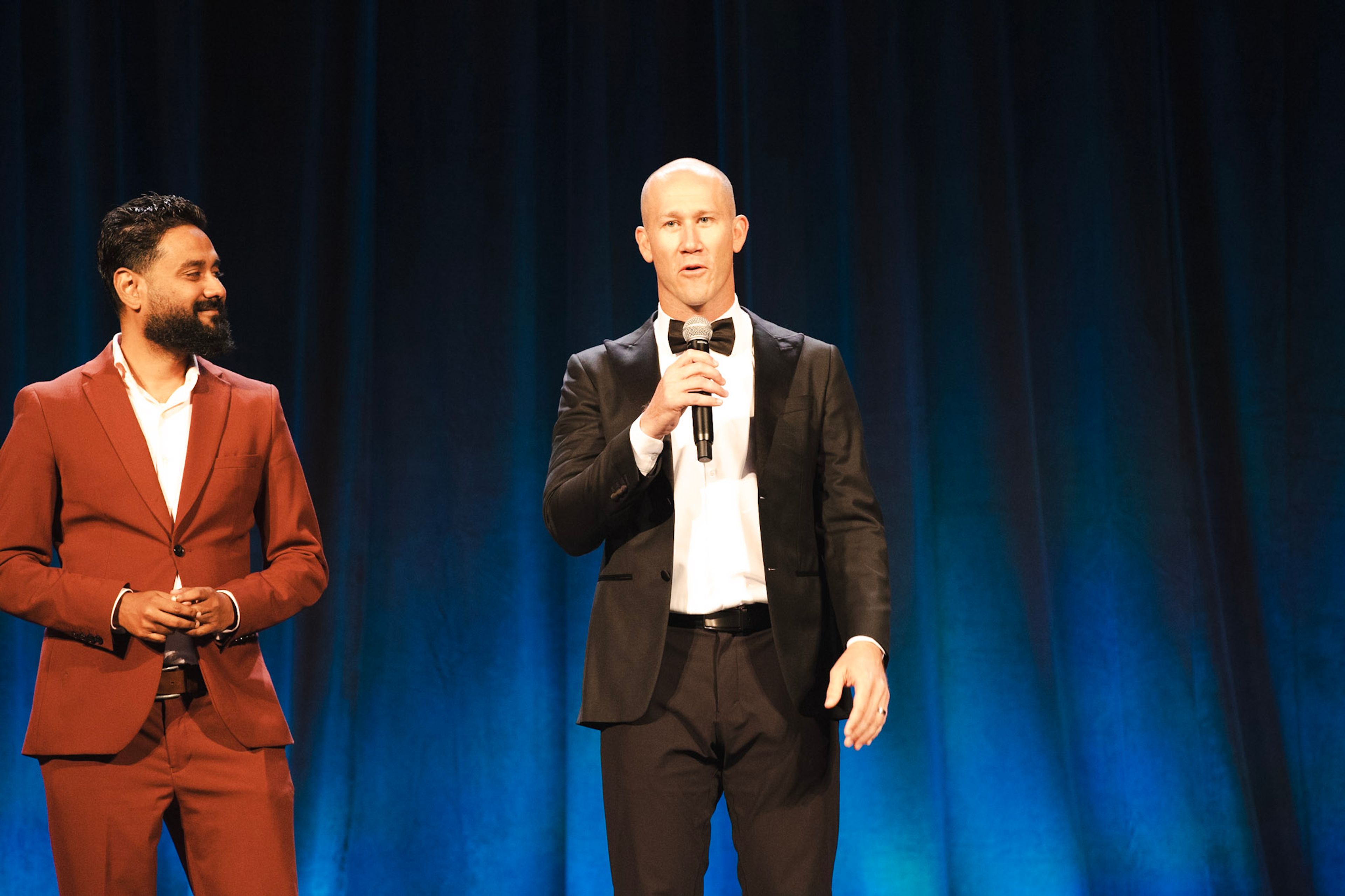 Taylor Candella on stage at the 2025 Toastmasters World Championship of Public Speaking, standing alongside the 2025 World Champion, Sabyasachi Sengupta.