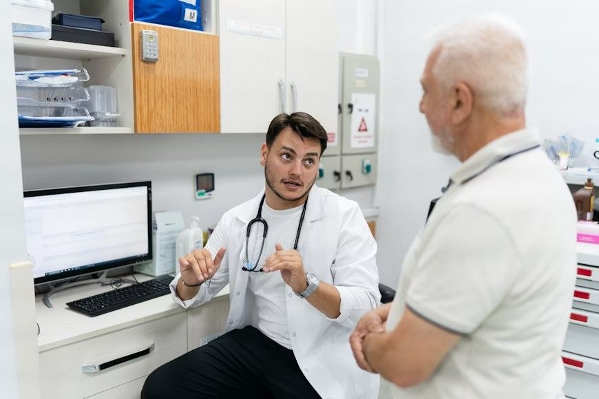 Doctor consulting an elderly patient in clinic