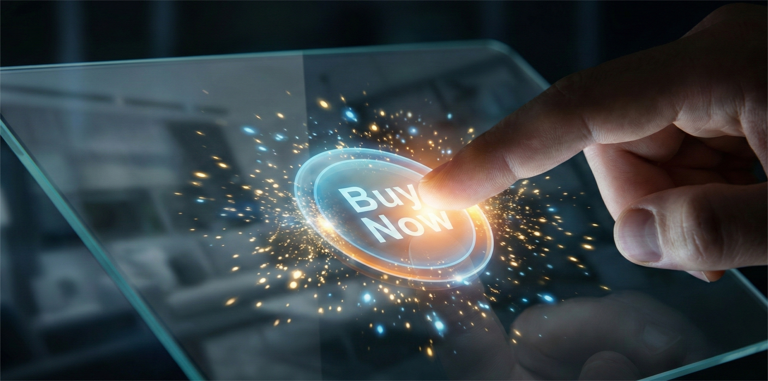 A close-up photograph of a person's index finger pressing a glowing, virtual "Buy Now" button on a transparent futuristic tablet screen. The interaction causes a burst of blue and orange digital light particles to explode from the touchpoint against a dark, blurred background.