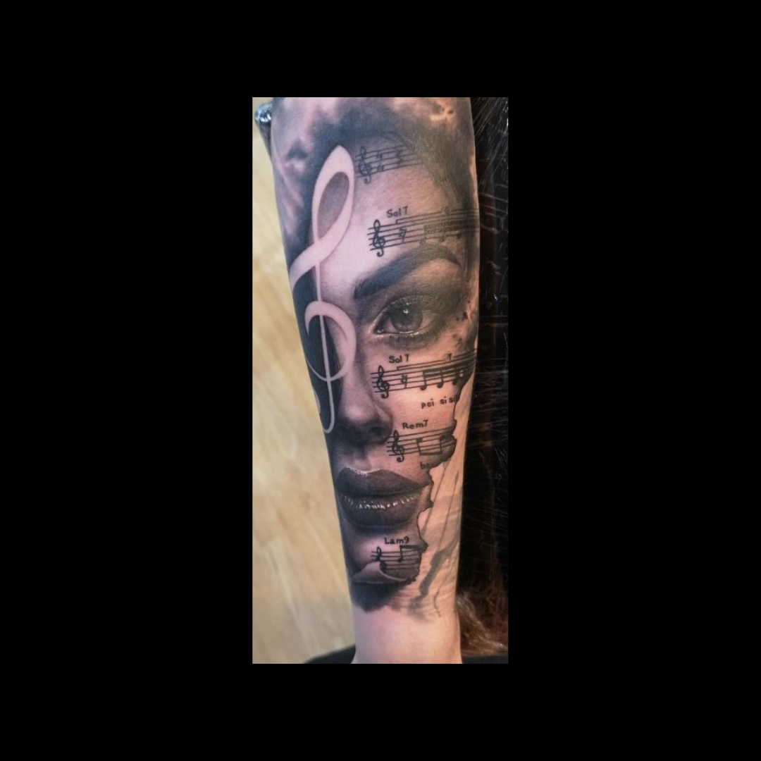 Women faces and musical notes Tattoo