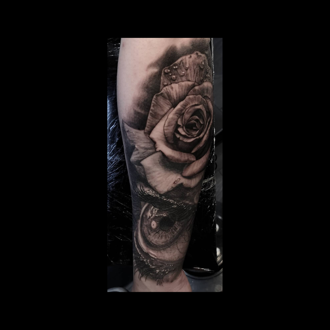 Rose and eye  arm tattoo