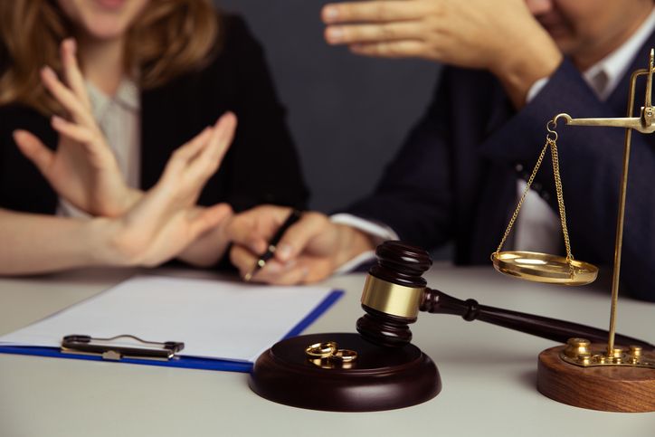 divorcing couple fighting in lawyer's office