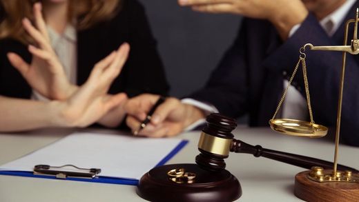 divorcing couple fighting in lawyer's office