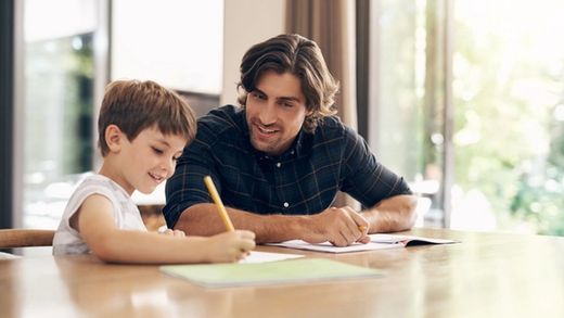 father helping son with homework