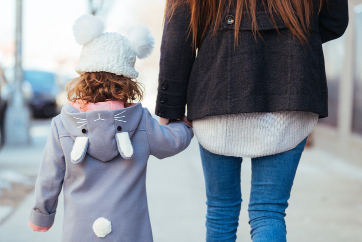 child holding mother's hand