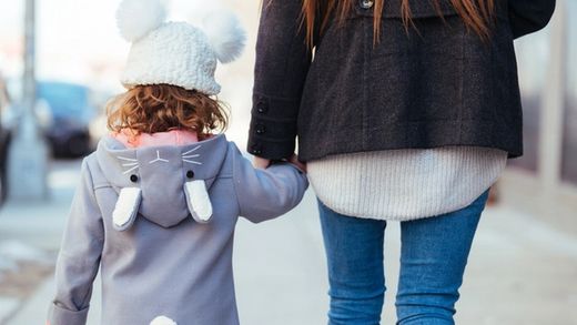 child holding mother's hand