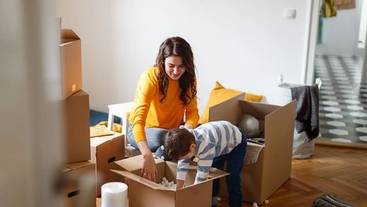 mother and son packing up moving boxes