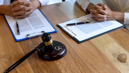 couple in law office about to sign divorce papers