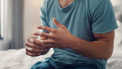 man removing wedding ring