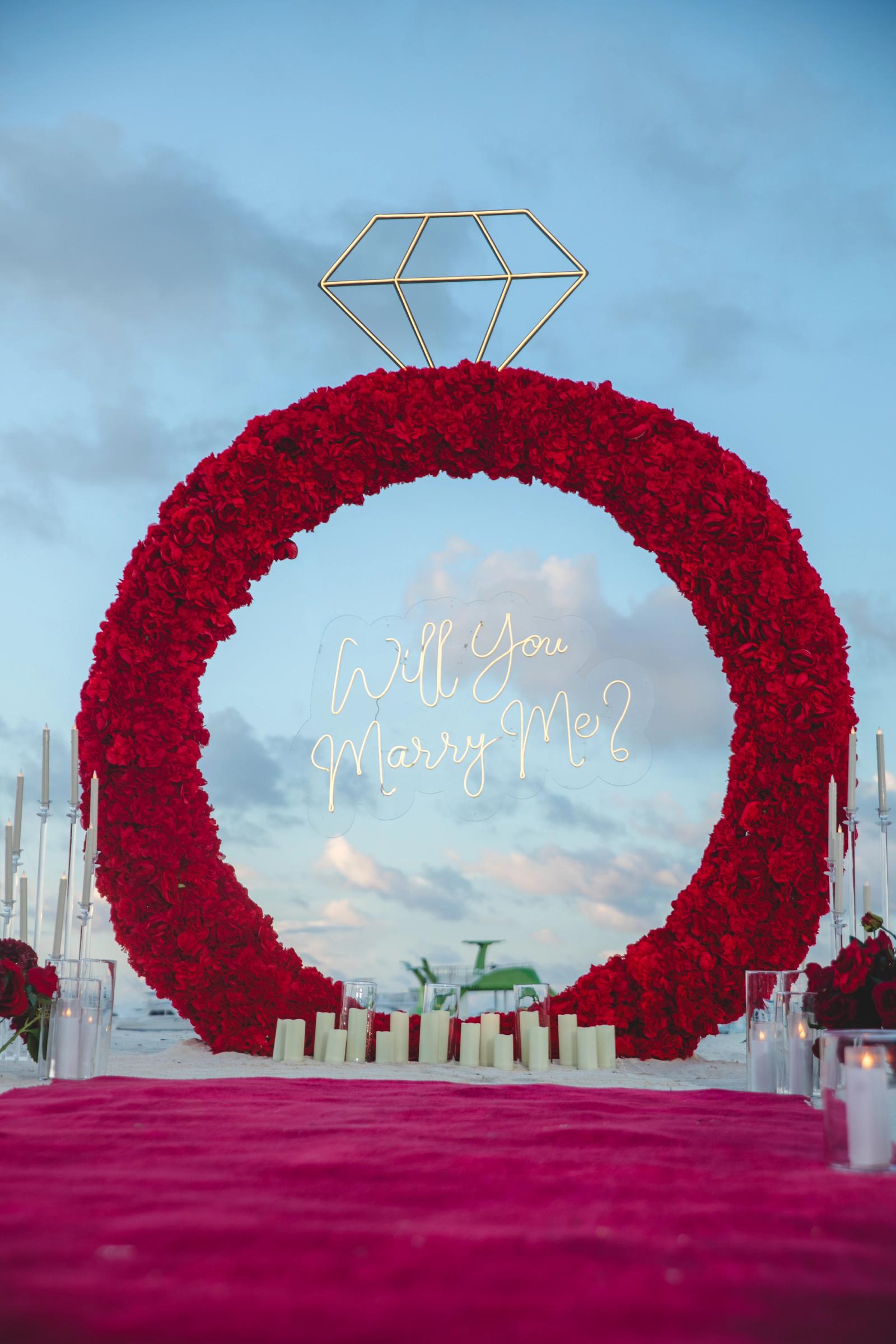 Endless Love: Vertical front view of the red floral ring and glowing diamond. Endless Love: Vertical front view of the red floral ring and glowing diamond.
