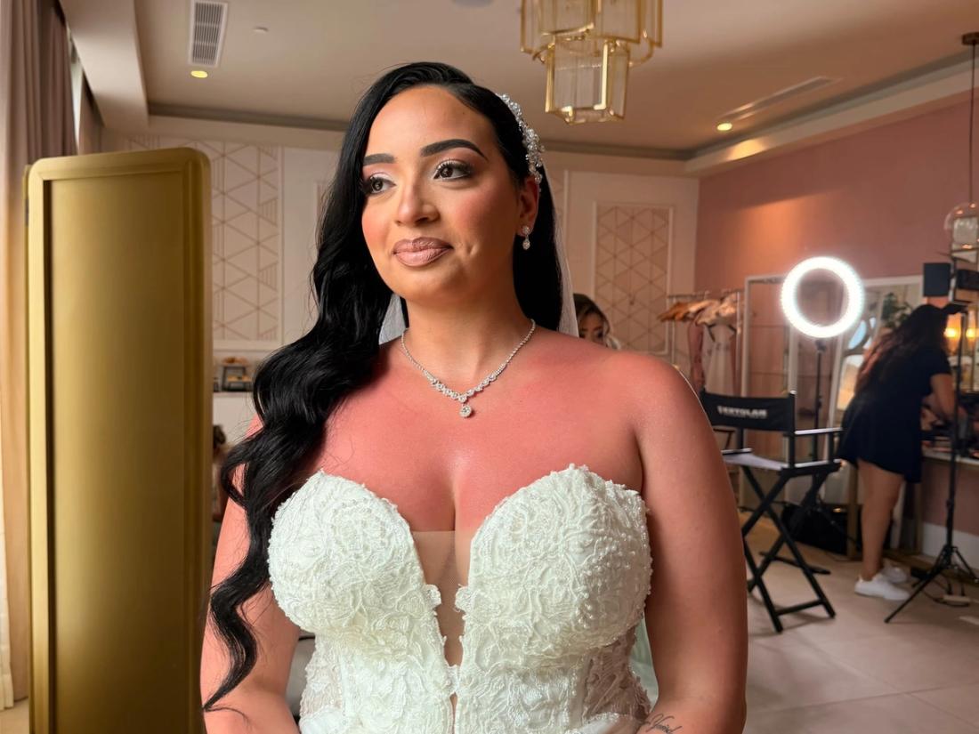 Bride holding a white rose bouquet before her Punta Cana wedding
