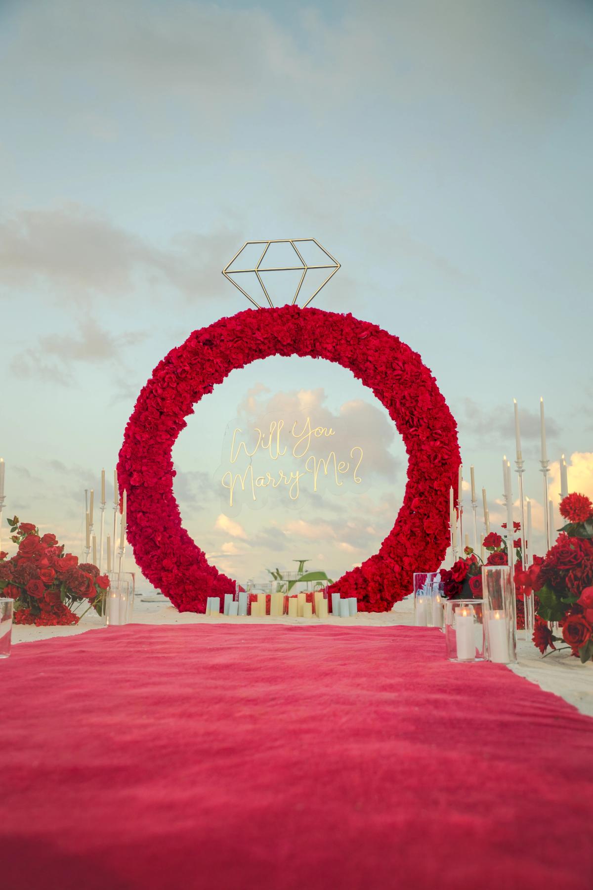 Red floral ring, glowing diamond and red carpet for an Endless Love beach proposal. Red floral ring, glowing diamond and red carpet for an Endless Love beach proposal.